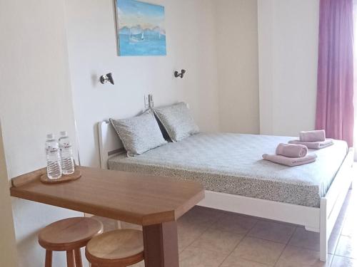 a small room with a bed and a table at FLORA STUDIOS CORFU - Adults only in Benitses