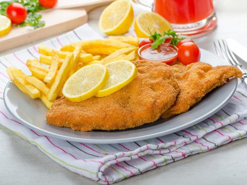 a plate of food with fish and french fries at Hotel Paffhausen in Wirges