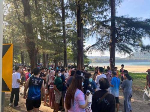 a crowd of people standing around in a park at Naiyang Beach Hotel SHA Plus in Nai Yang Beach