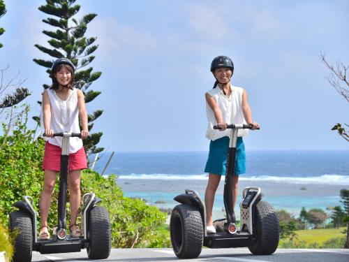two young girls riding on segifts on the beach at Hotel Shigira Mirage Beach Front in Miyako Island