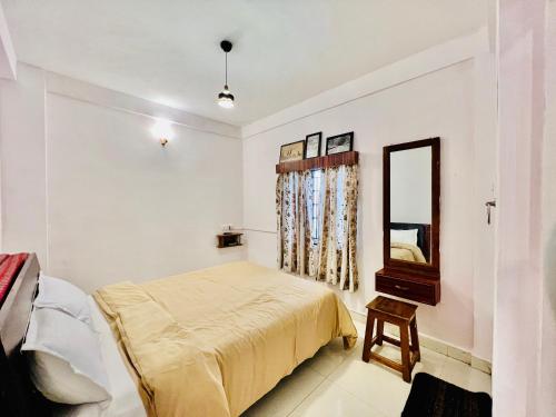 Кровать или кровати в номере Little House Ooty