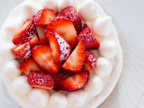 a plate of strawberries on top of a cake at Hotel Shigira Mirage Beach Front in Miyako Island