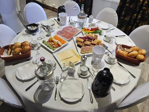 a white table with food on top of it at Hotel Paffhausen in Wirges
