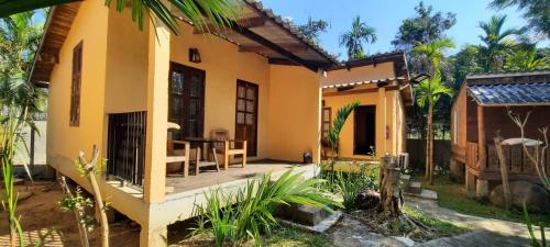 a house with a wooden deck in the yard at Mountainblues in Kampong Huaibū