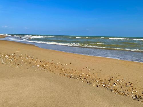 a beach with a lot of rocks in the sand at HomeState Bang Maprao in Ban Hin Sam Kon