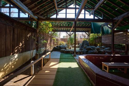 a building with a garden with a pathway with grass at Royal Hotel Kawaguchiko in Fujikawaguchiko