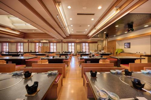 a large room with tables and chairs in a room at Royal Hotel Kawaguchiko in Fujikawaguchiko