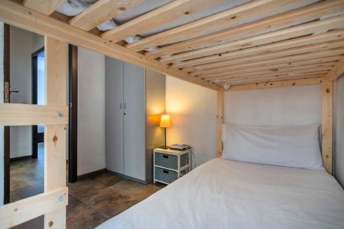 a bedroom with a large bed with a wooden ceiling at 3BD with private terrace right by Sagrada Familia in Barcelona