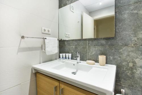 a bathroom with a white sink and a mirror at Centric 2bedroom in Las Ramblas 3 1A in Barcelona