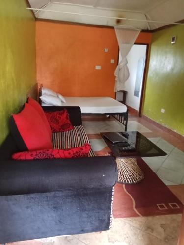 a living room with a couch and a table at Yaya kilimani cottage B in Nairobi