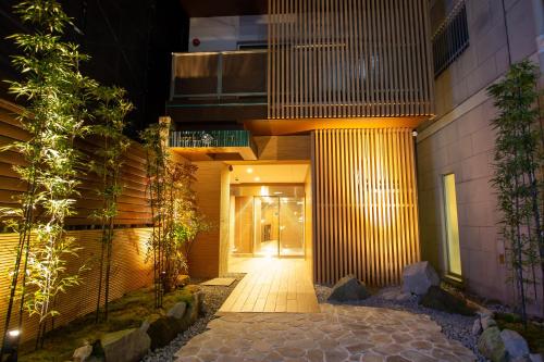 a hallway leading to a building at night at Hotel Fu-Rin in Fukuoka