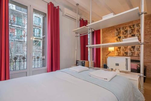 Schlafzimmer mit einem großen Bett und roten Vorhängen in der Unterkunft Exclusive 2 bedroom apartment in the city center in Barcelona
