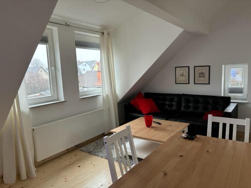 a living room with a table and a couch at Wick Home Apartment 3 Lahr-Burgheim in Burgheim