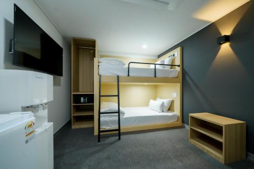 a small room with bunk beds and a tv at The Stay Hue Myeongdong in Seoul