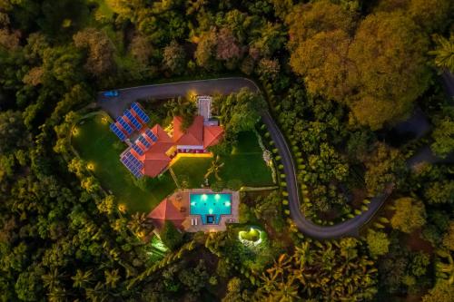 an aerial view of a house with a pool at StayVista at Moksh Villa - BBQ & Jacuzzi in Alibaug