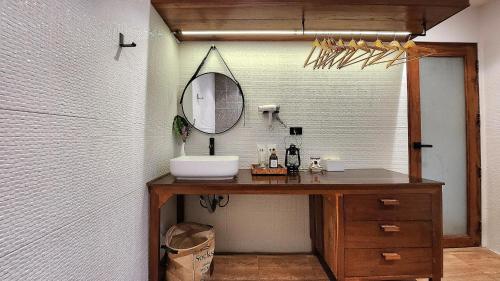 a bathroom with a sink and a mirror at MayamYay Privacy Homestay @Mea Nea Chiang Dao in Chiang Dao