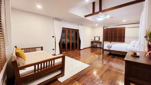 a living room with a bed and a couch at MayamYay Privacy Homestay @Mea Nea Chiang Dao in Chiang Dao