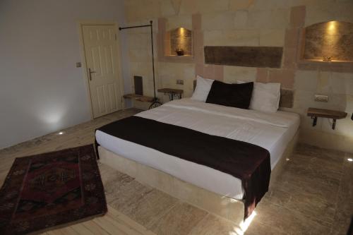 a bedroom with a large white bed in a room at Philosophy Hotel in Uchisar