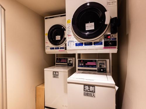 two washing machines and a washer and dryer in a room at Hotel Gracery Kyoto Sanjo in Kyoto