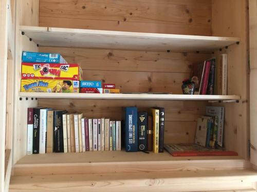 a book shelf full of books in a room at Belle maison traditionnelle - Les Chavonnes in Courchevel