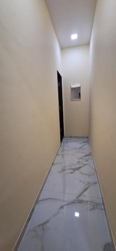 a hallway with a marble floor in a room at Savali Lodging and Boarding in Chālisgaon