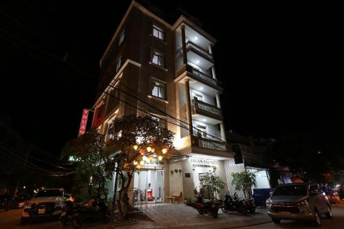 a tall building with lights on it at night at Thuận Hải Hotel PQ - by BAY LUXURY in Phu Quoc
