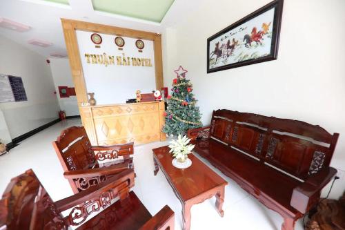 a living room with a christmas tree on the wall at Thuận Hải Hotel PQ - by BAY LUXURY in Phu Quoc