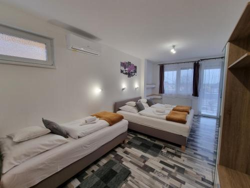 a living room with two beds and a couch at Heléna Hotel & SPA in Levél