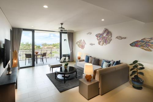 a living room with a couch and a table at Anantara Vacation Club Mai Khao Phuket in Mai Khao Beach