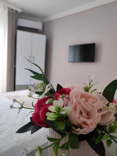 a bouquet of flowers in a vase on a table at DiP HOME APARTMENTS in Pomorie
