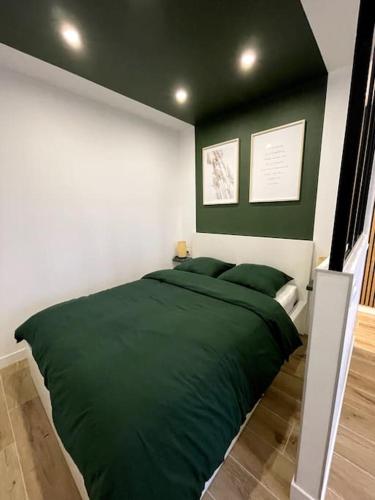 a bedroom with a bed with green sheets at HOME GREEN TOUCH - Fibre*Near Basel*Cosy in Saint-Louis