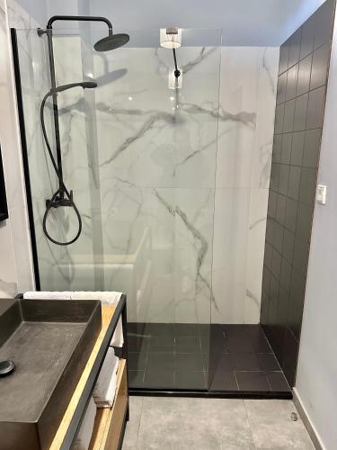 a bathroom with a shower with a glass door at Anifora Seaview Villa in Agios Pavlos
