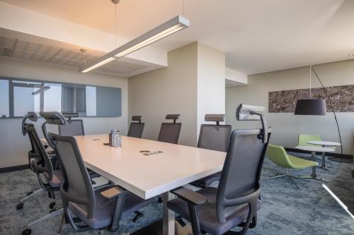an office with a conference room with a table and chairs at Crowne Plaza Antwerpen by IHG in Antwerp