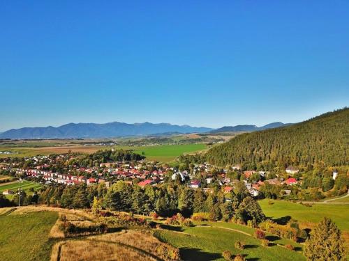 an aerial view of a small village in the hills at Chata pri Kaštieli 