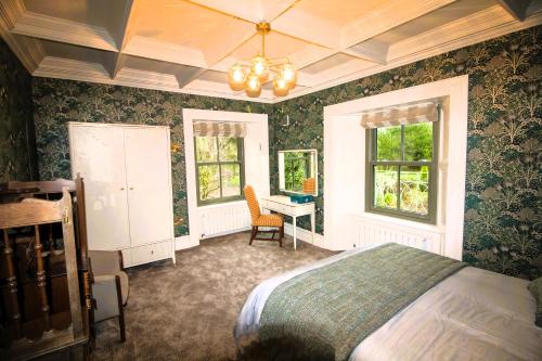 a bedroom with a bed and a desk in it at Glenastar Lodge in Newcastle West