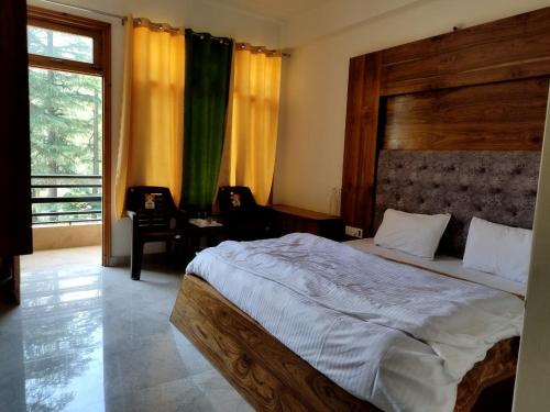 a bedroom with a large bed and a large window at Pranays House in Mumbai