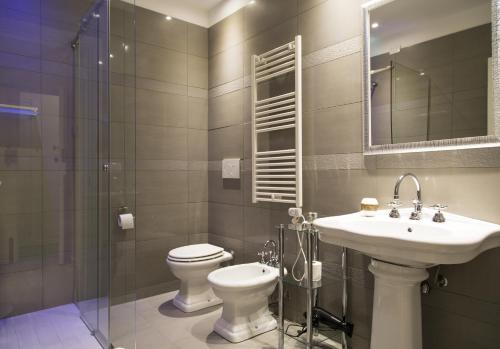 a bathroom with a toilet and a sink and a shower at Navigliotel 19 - Rooms & Suites in Milan