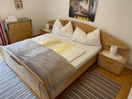 a wooden bed with pillows on it in a bedroom at Sepp, Haus in Finkenberg