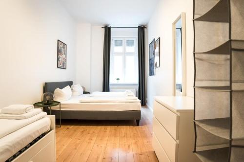 a bedroom with a bed and a mirror at Great Apartment for Eight in Berlin Neukölln in Berlin