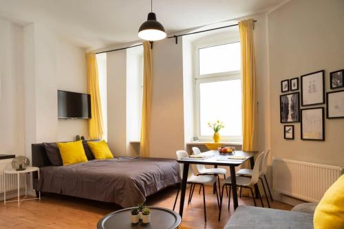 a bedroom with a bed and a table with chairs at Lovely Apartment in the near of Kudamm in Berlin