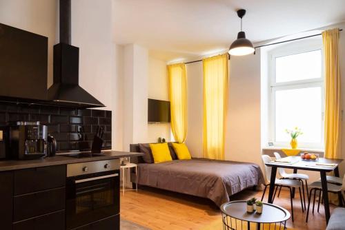 a bedroom with a bed and a kitchen with a table at Lovely Apartment in the near of Kudamm in Berlin