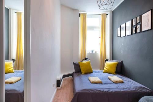 a bedroom with two beds with yellow pillows at 2 Bedroom in great location in Kreuzberg in Berlin