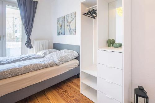 1 dormitorio con armarios blancos y 1 cama en Cosy 2-room Apartment in urban location, en Hamburgo