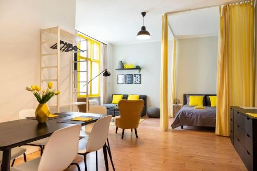 a living room with a dining table and a bedroom at Great Apartment close to Kudamm in Berlin