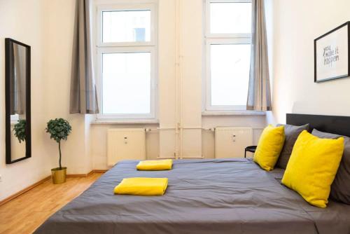 a bedroom with a large bed with yellow pillows at One Bedroom Apartment Berlin Neukölln in Berlin