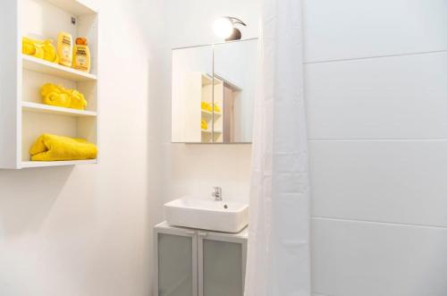 een witte badkamer met een wastafel en een spiegel bij Modern 2 Bedroom Apartment in Berlin Schöneberg in Berlijn