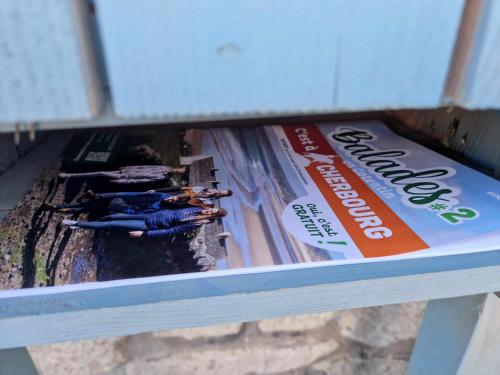 a magazine sitting on top of a shelf at Villa Fresquet in Cherbourg en Cotentin