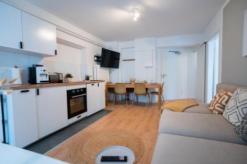 a living room with a couch and a kitchen at Hamburg City Apartment for 7 in Hamburg