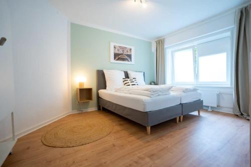 a bedroom with a bed and a large window at Hamburg City Apartment for 7 in Hamburg