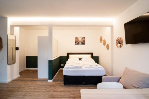 a room with two beds and a couch at Hamburg - Cosy Apartment for 4 in Hamburg